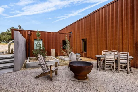 a living room with furniture a fireplace and a large window