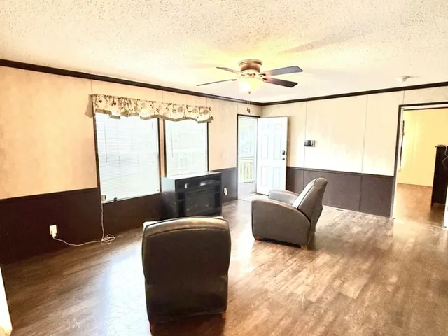 a living room with furniture and large window