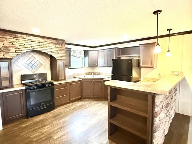 a kitchen with a stove a sink and a refrigerator