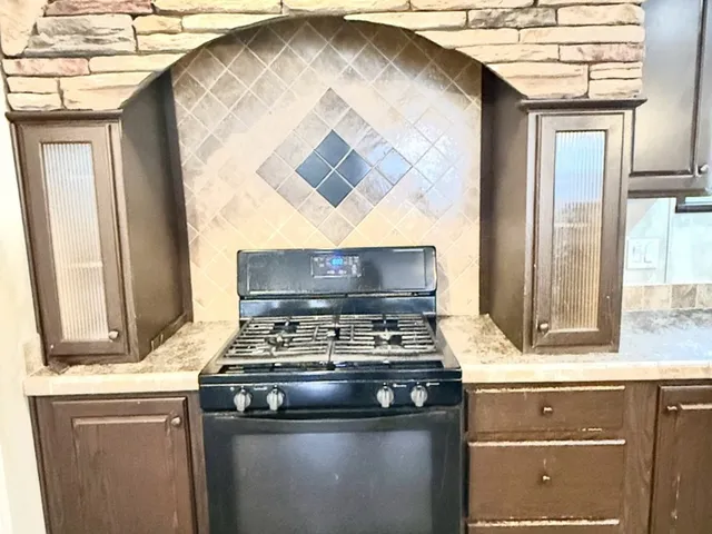 a kitchen with a stove and a sink