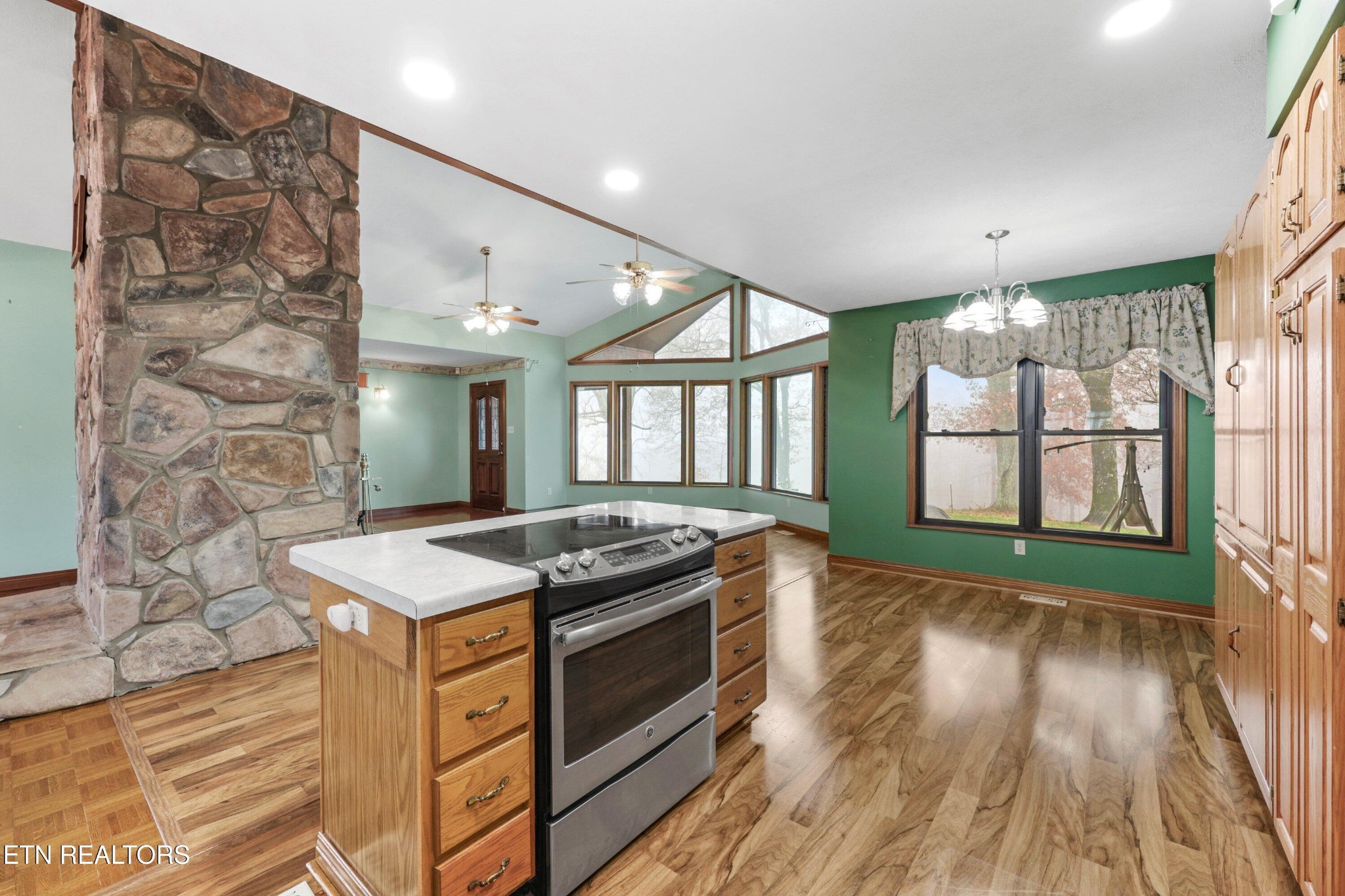 235 Davidson Hollow Road Heiskell, TN 37754 - Photo 33 of 43 a kitchen that has a sink a stove and wooden floor
