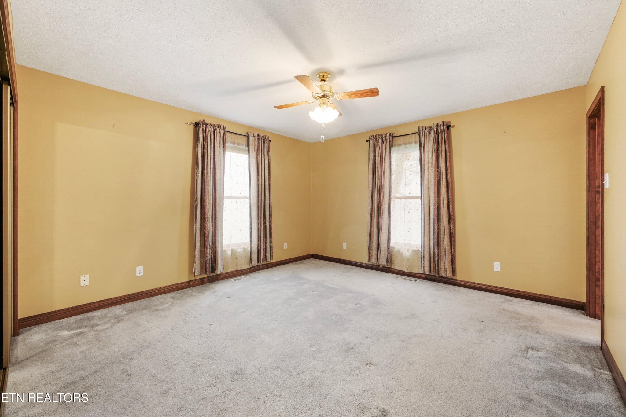 235 Davidson Hollow Road Heiskell, TN 37754 - Photo 40 of 43 an empty room with windows and fan