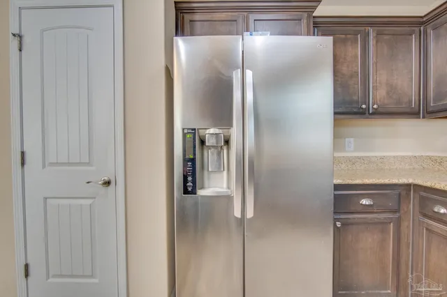 a kitchen with a refrigerator and cabinets