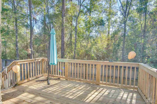 a view of a patio with a table and chairs and wooden floor