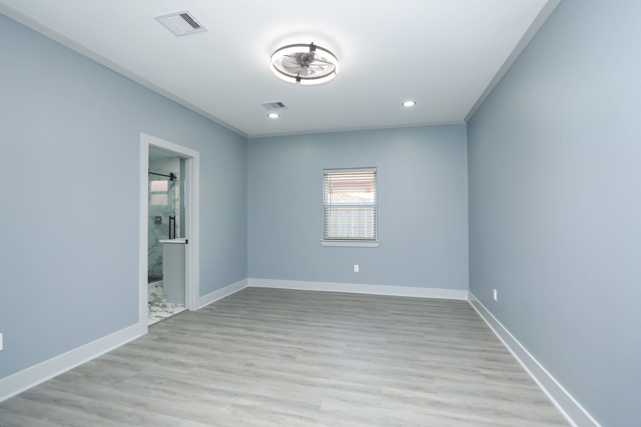 4047 Juliet Street Houston, TX 77087 - Photo 21 of 38 an empty room with wooden floor and windows