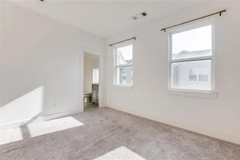 an empty room with windows and closet