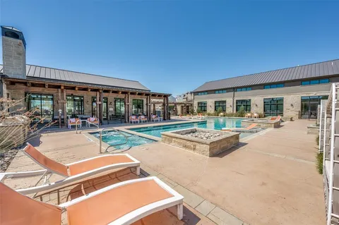 a view of a house with sitting area and swimming pool