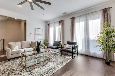 a living room with furniture and large windows