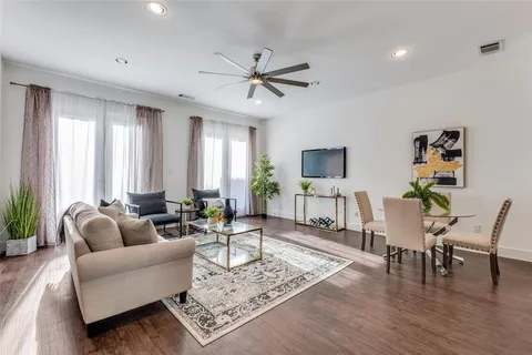 a living room with furniture and wooden floor