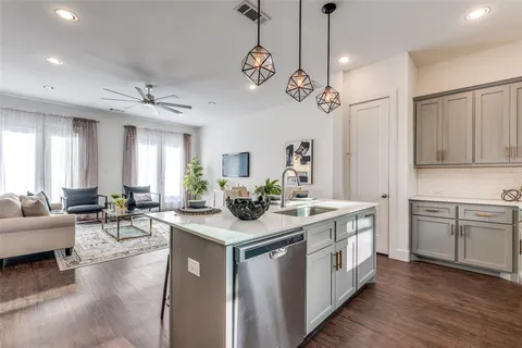 a kitchen with a stove a sink a dining table and chairs