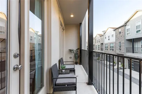 a view of a balcony with furniture and a porch