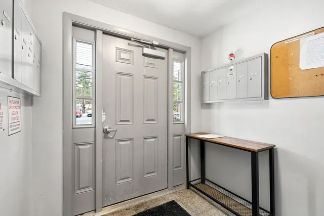 an empty room with windows & cabinet