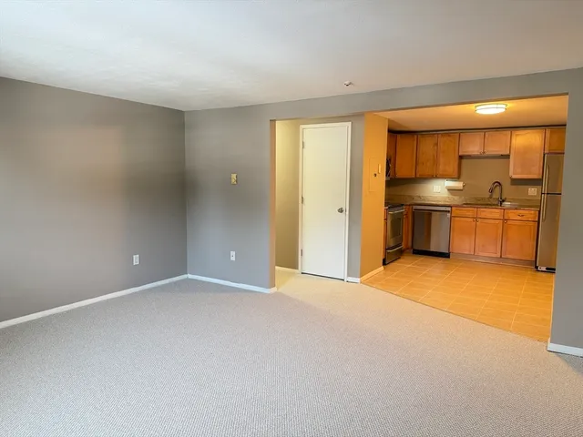a kitchen with a sink a refrigerator and cabinets