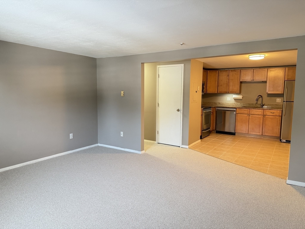 870 Haverhill Street, Unit 21B Rowley, MA 01969 - Photo 4 of 14 a view of an empty room with a window