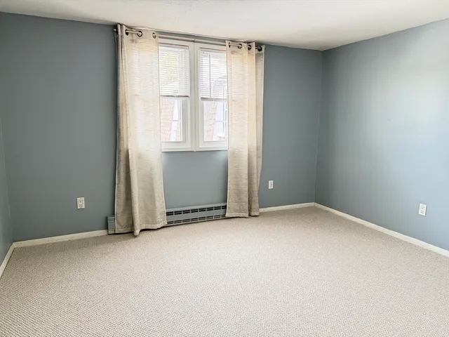 a view of an empty room and a window