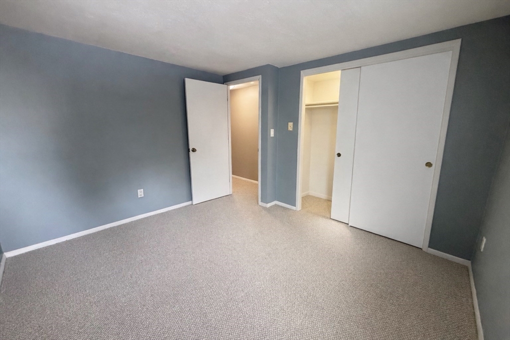 870 Haverhill Street, Unit 21B Rowley, MA 01969 - Photo 10 of 14 a view of an empty room and a window