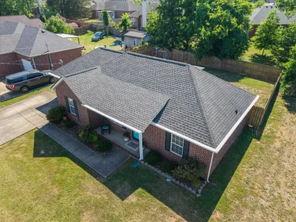 an aerial view of a house with a yard table and chairs