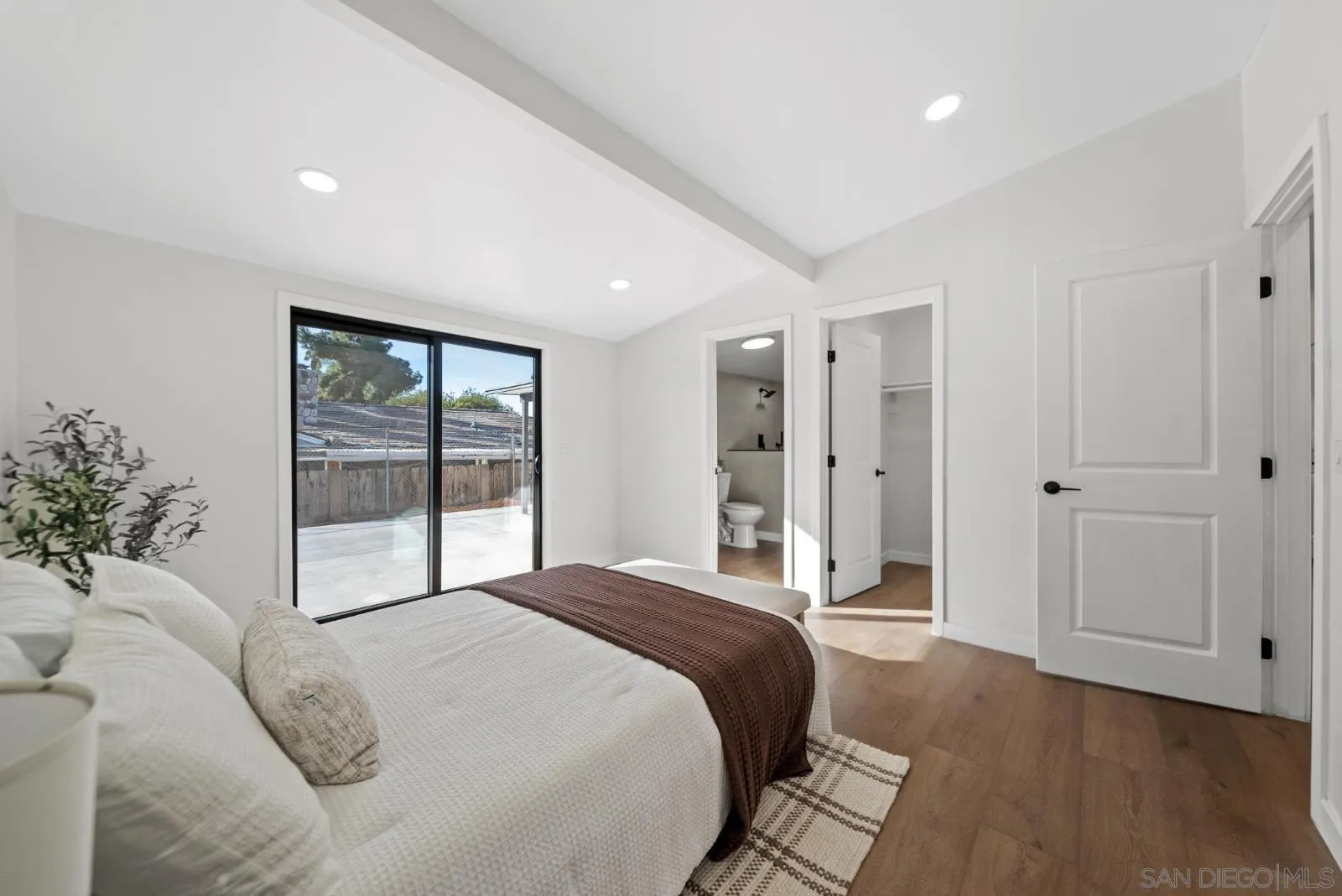 661 Concepcion Avenue Spring Valley, CA 91977 - Photo 20 of 43 a spacious bedroom with a large bed and a chandelier