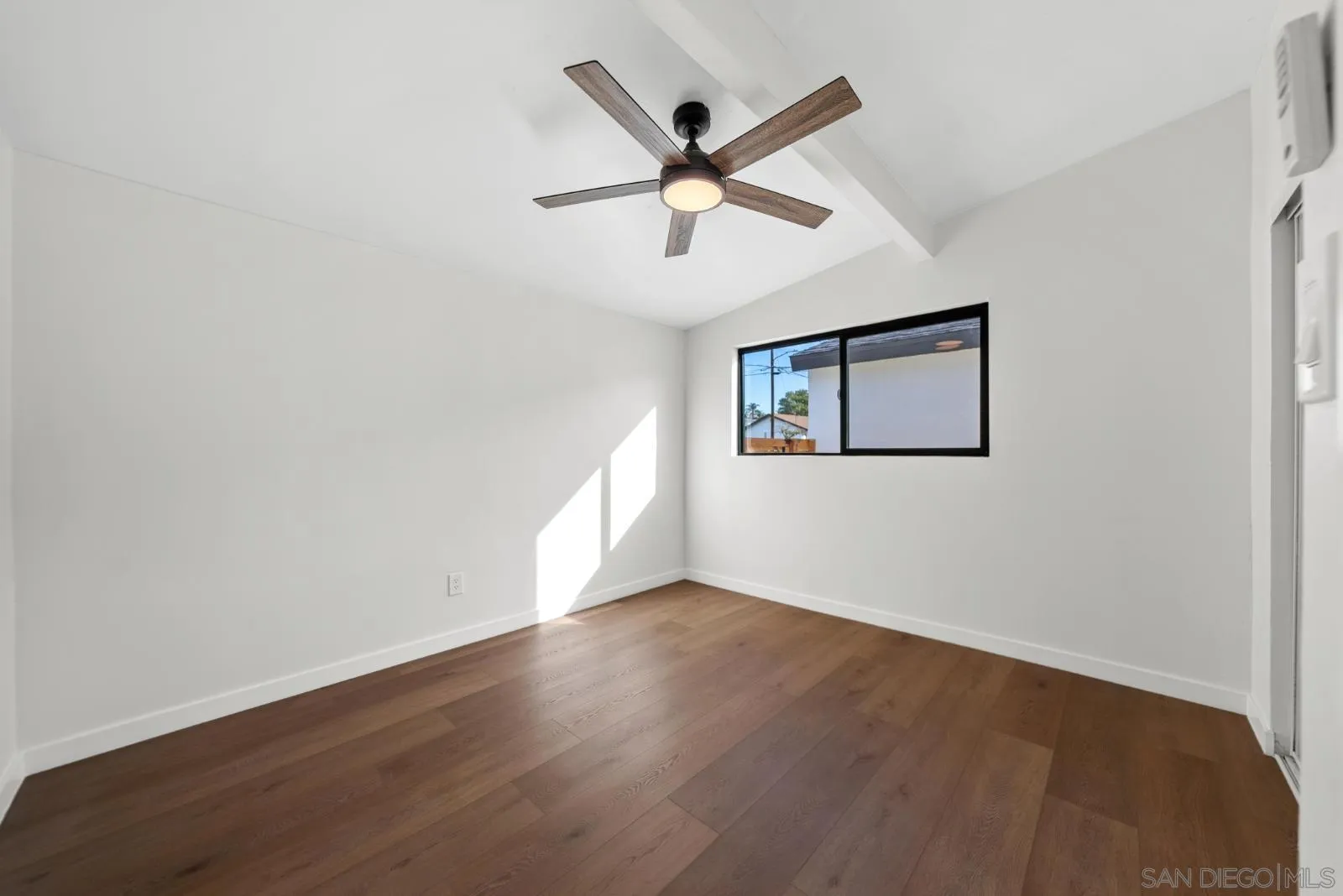 661 Concepcion Avenue Spring Valley, CA 91977 - Photo 27 of 43 an empty room with wooden floor and ceiling fan