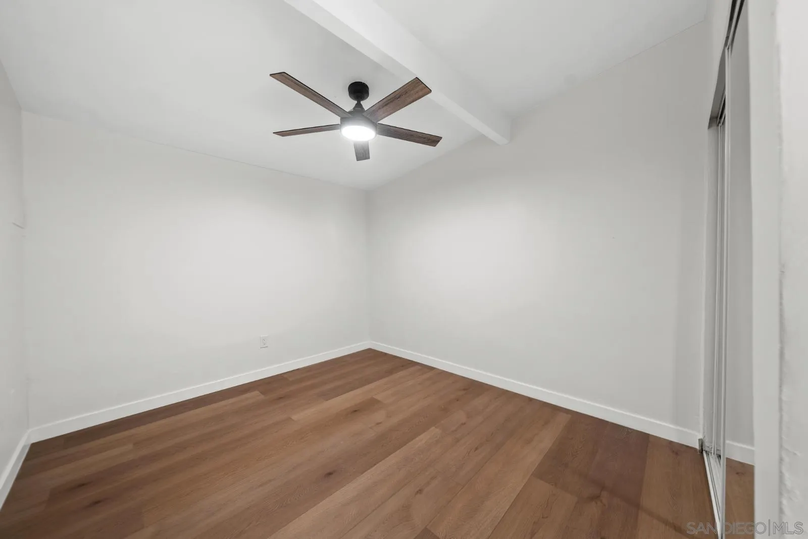 661 Concepcion Avenue Spring Valley, CA 91977 - Photo 28 of 43 an empty room with wooden floor fan and windows