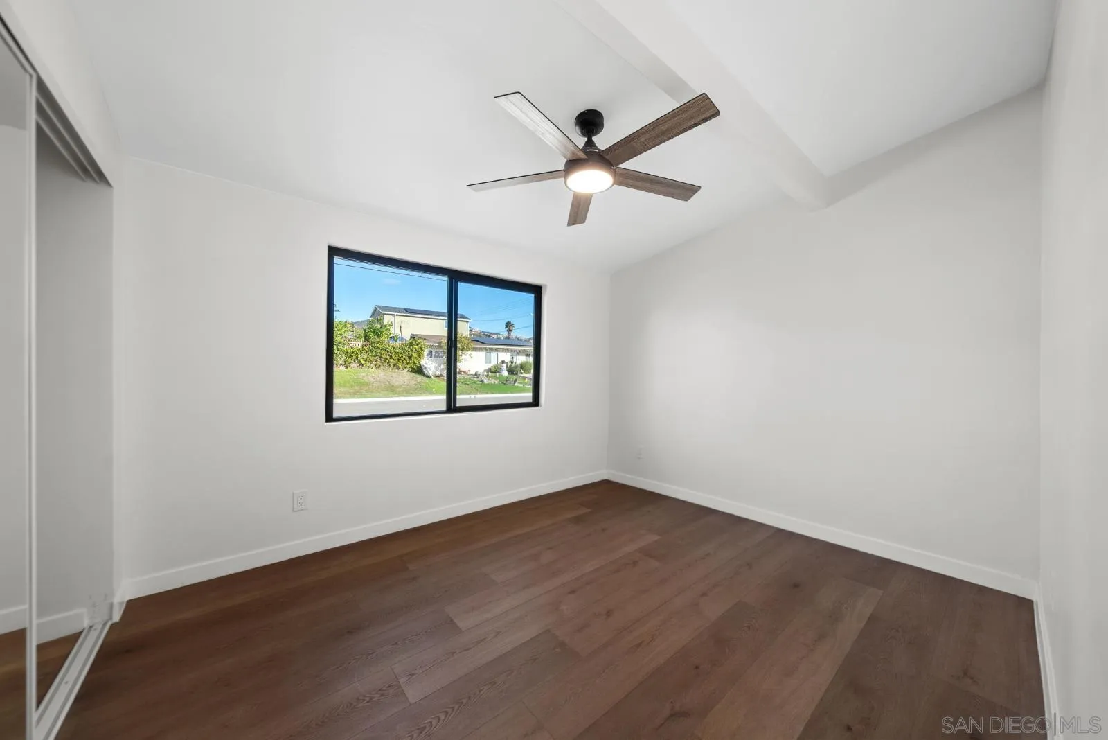 661 Concepcion Avenue Spring Valley, CA 91977 - Photo 29 of 43 an empty room with wooden floor ceiling fan and windows