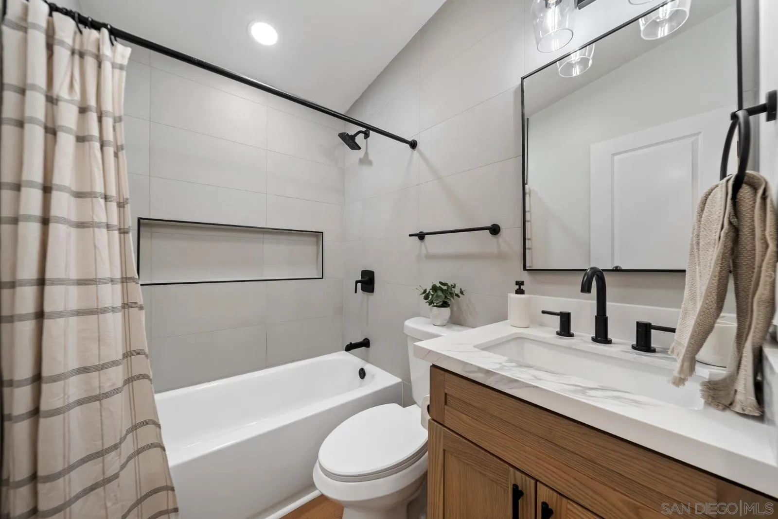 661 Concepcion Avenue Spring Valley, CA 91977 - Photo 30 of 43 a bathroom with a granite countertop bathtub shower sink vanity mirror and toilet