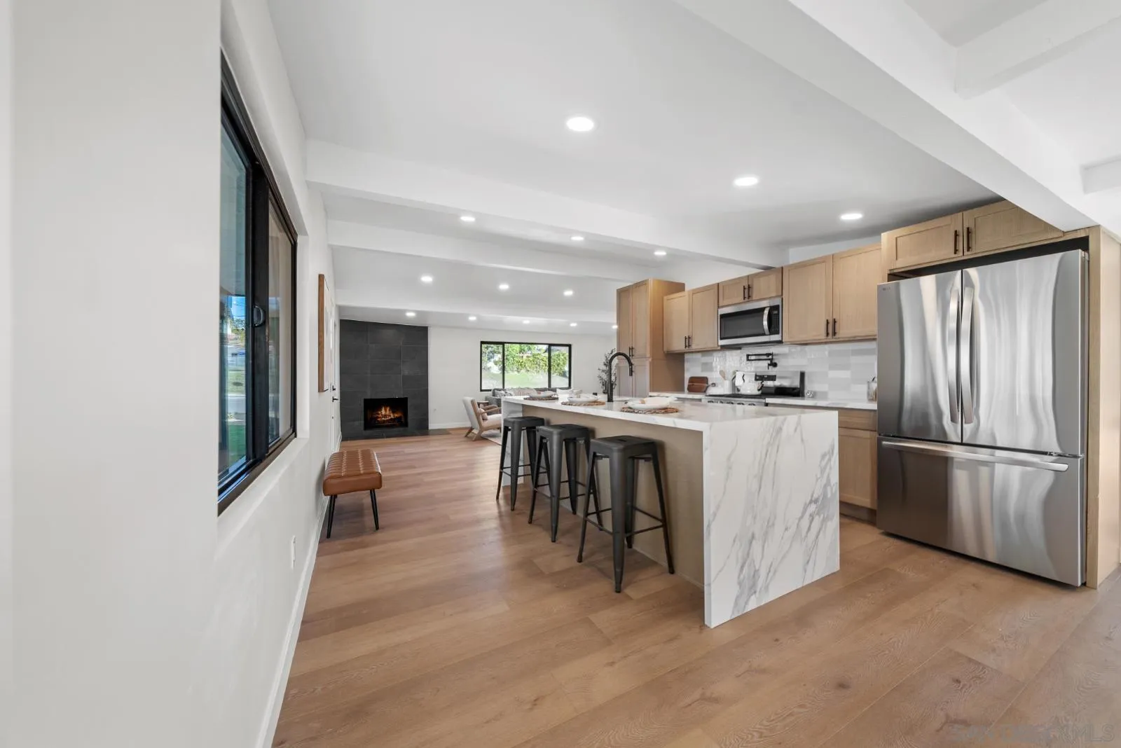 661 Concepcion Avenue Spring Valley, CA 91977 - Photo 9 of 43 a kitchen with kitchen island a refrigerator a stove a microwave oven with a dining table and chairs