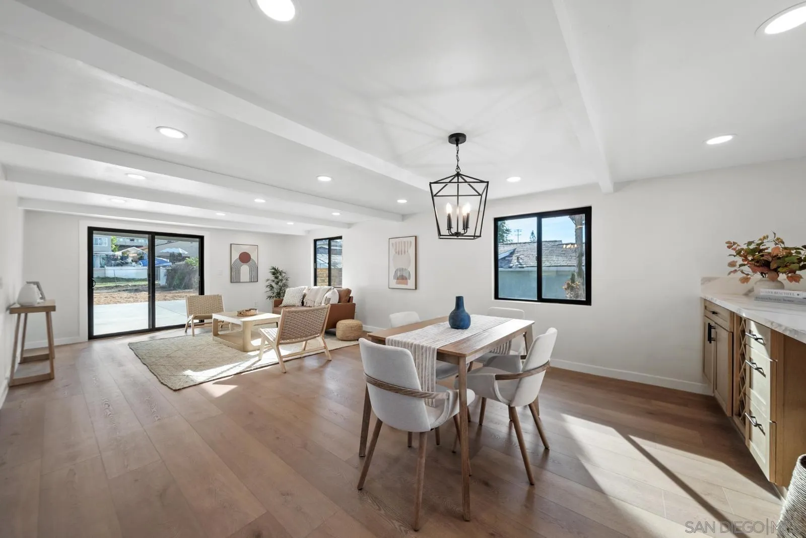 661 Concepcion Avenue Spring Valley, CA 91977 - Photo 10 of 43 a view of a dining room with furniture a chandelier and wooden floor