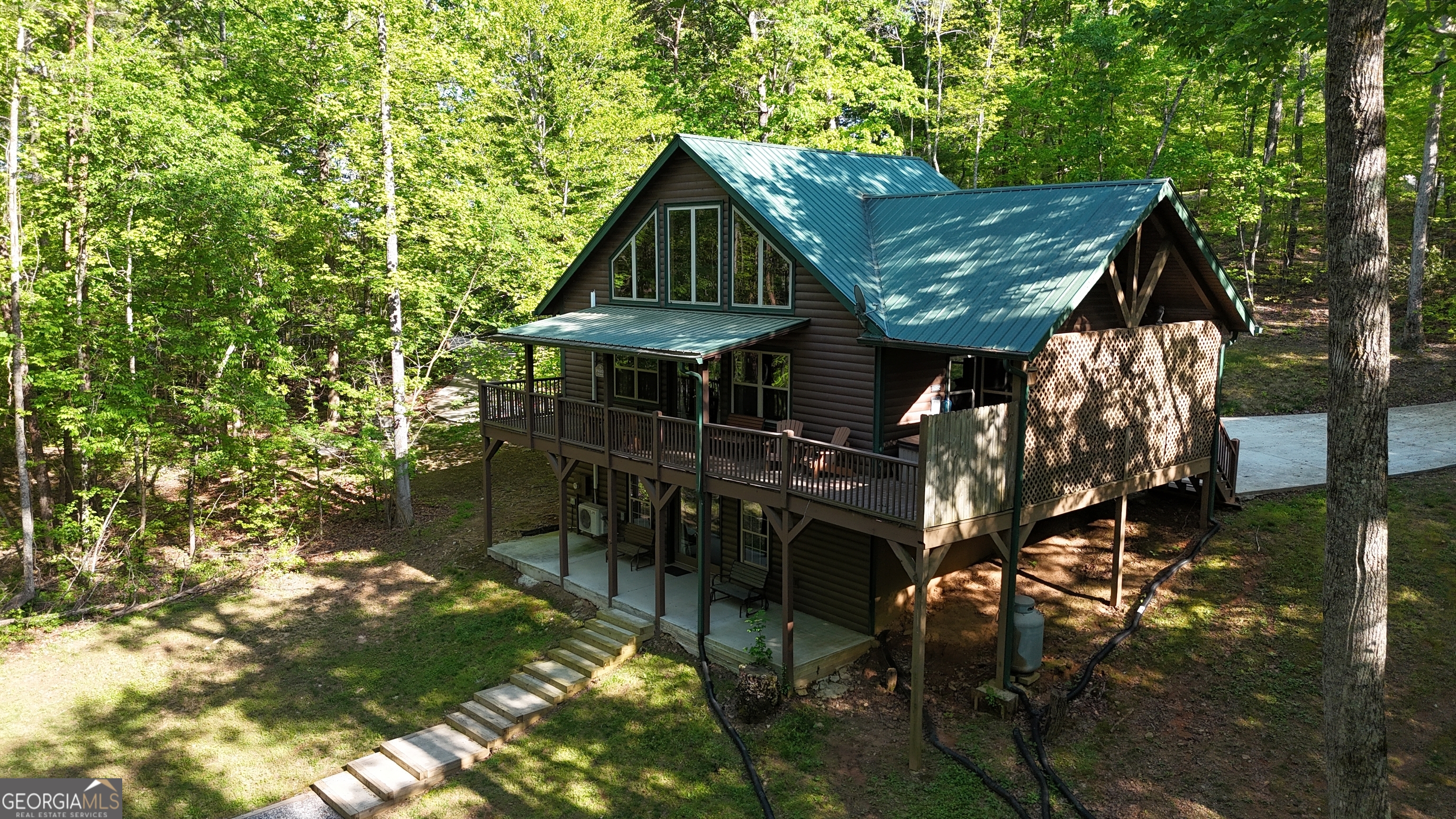 a view of house with backyard outdoor seating and hardwood