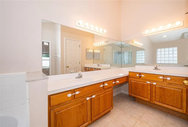 a spacious bathroom with a granite countertop sink and a mirror