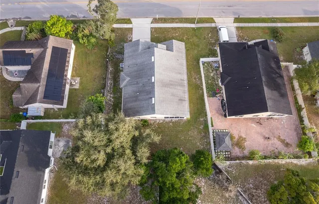 an aerial view of a house with outdoor space