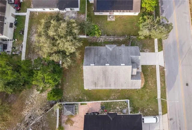 an aerial view of a house with a yard
