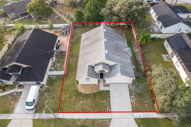 an aerial view of residential houses with outdoor space