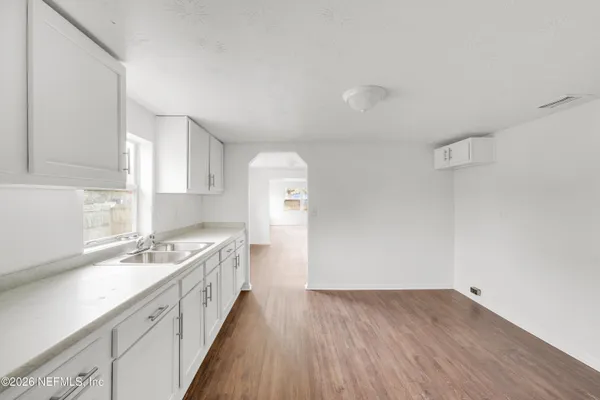 a spacious bathroom with a sink and a large mirror