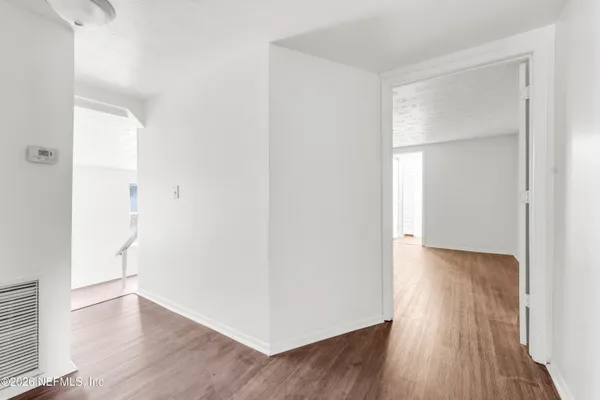 a view of a room with wooden floor