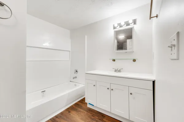 a bathroom with a bathtub and a sink