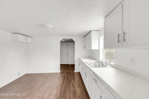 a kitchen with a sink stove and cabinets