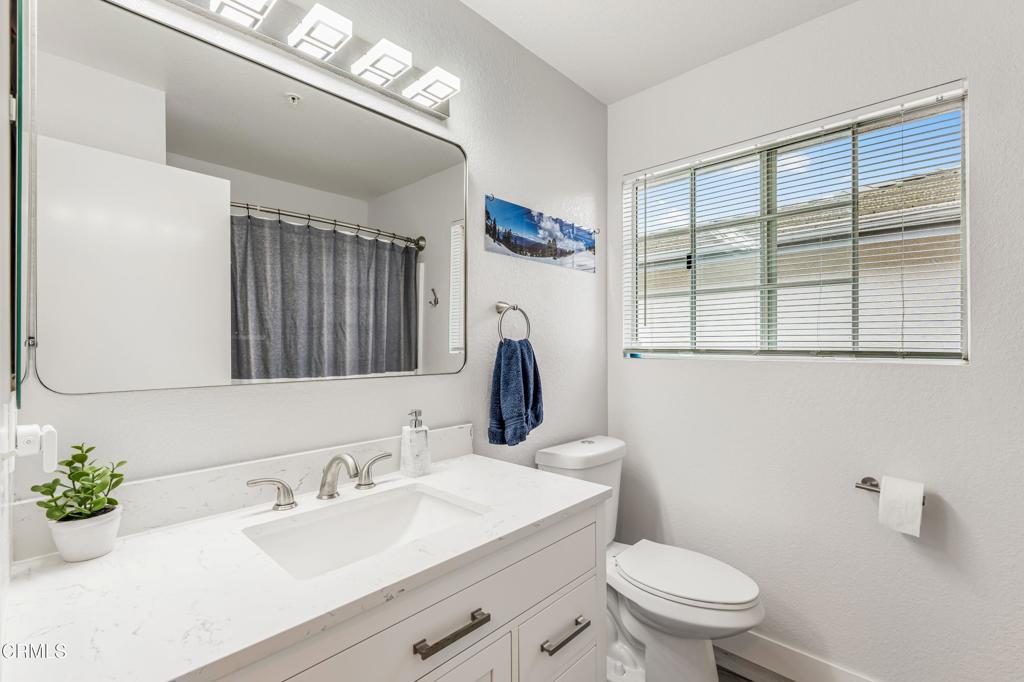 517 Orilla Walk Oxnard, CA 93030 - Photo 19 of 34 a bathroom with a granite countertop sink mirror vanity and toilet
