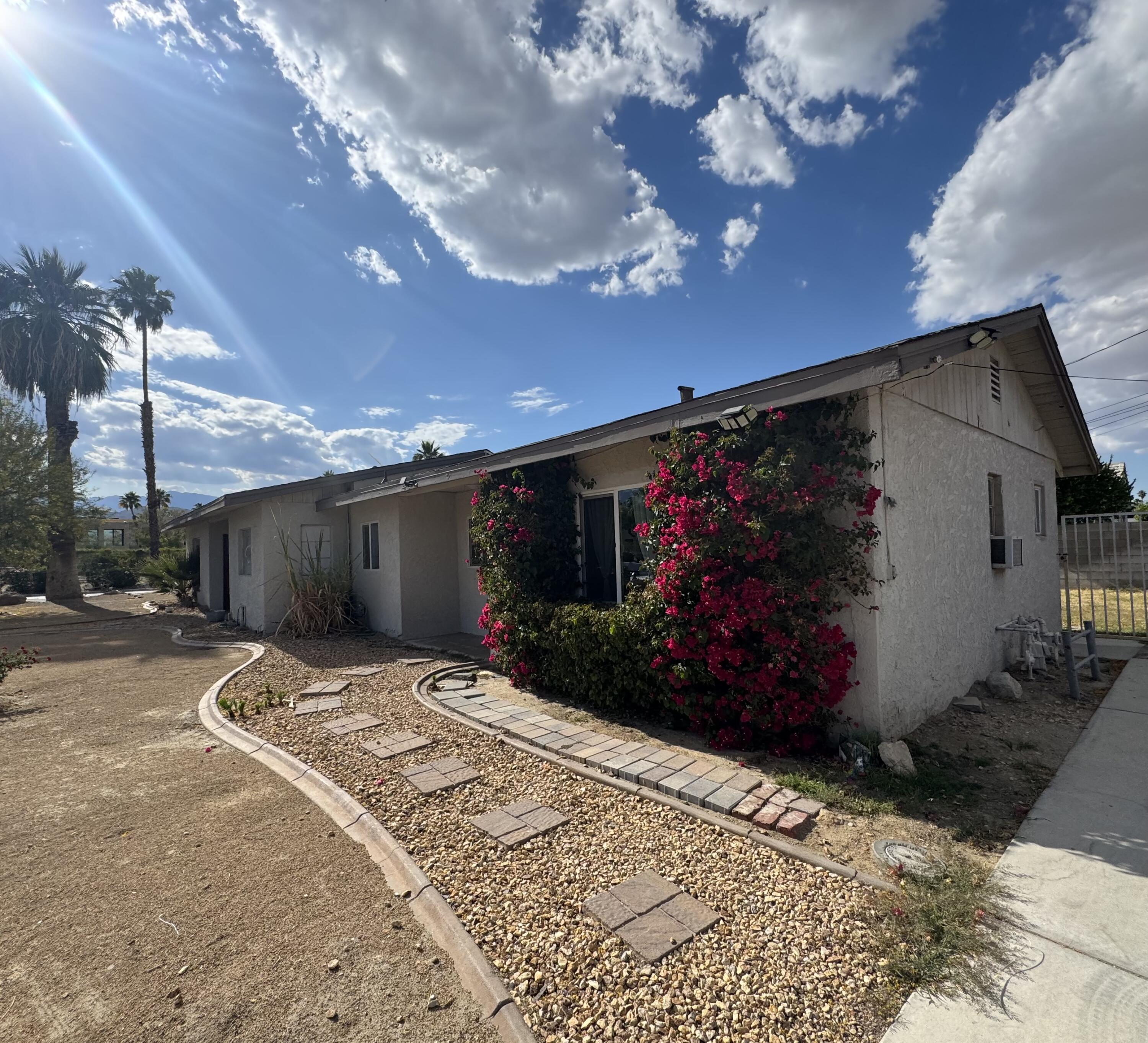 73760 Rancho Road Palm Desert, CA 92260 - Photo 3 of 27 a view of a house with a yard