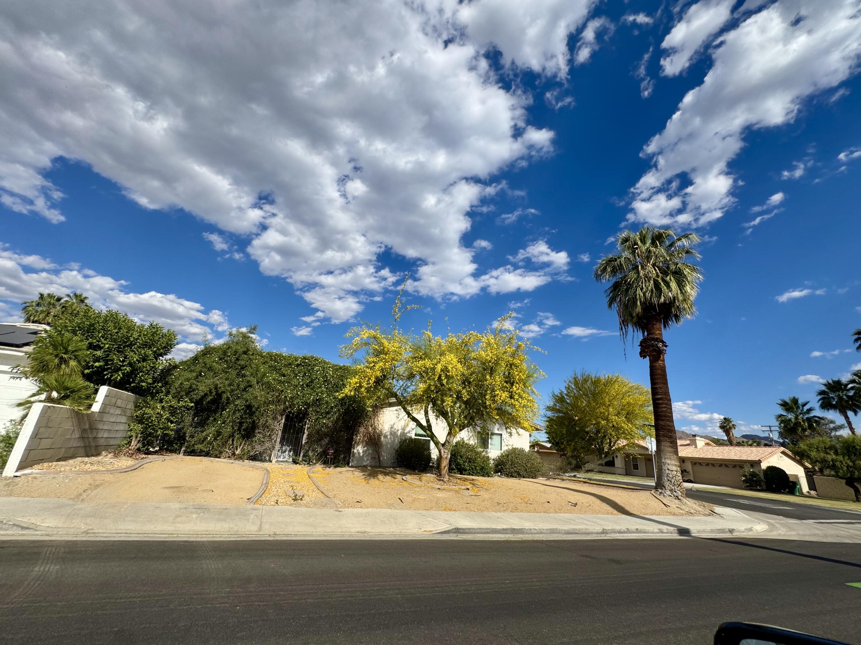 73760 Rancho Road Palm Desert, CA 92260 - Photo 4 of 27 a view of a street with a building in the background