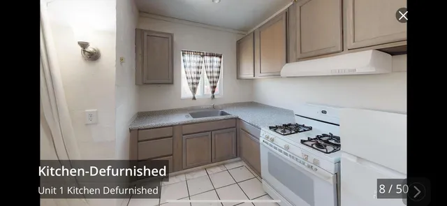 a stove top oven sitting inside of a kitchen