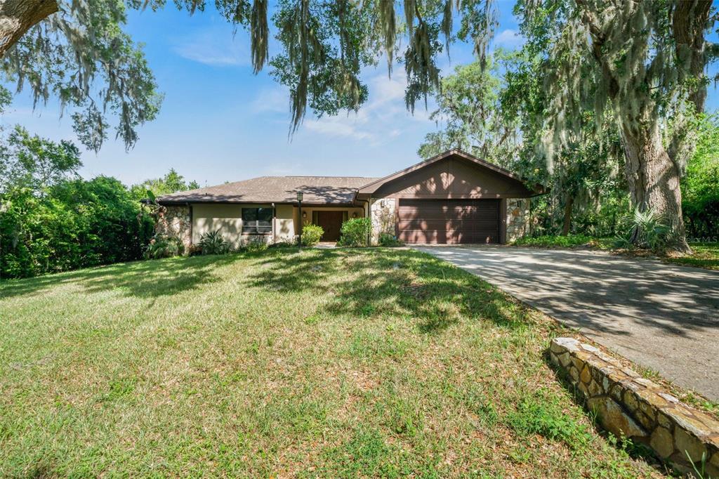 4401 East Windmill Drive Inverness, FL 34453 - Photo 1 of 65 a front view of a house with a yard
