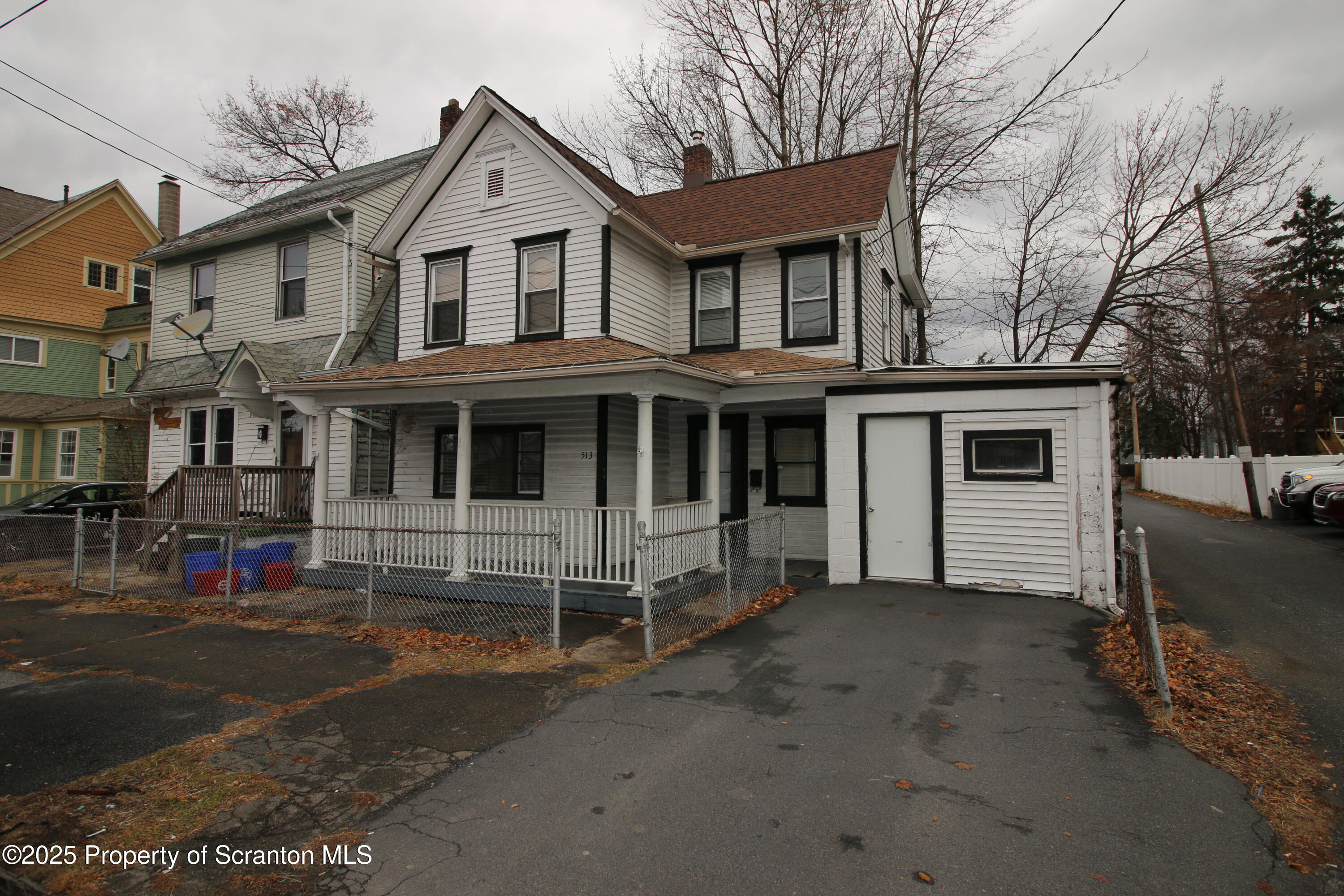 a view of a house with a yard and large windows