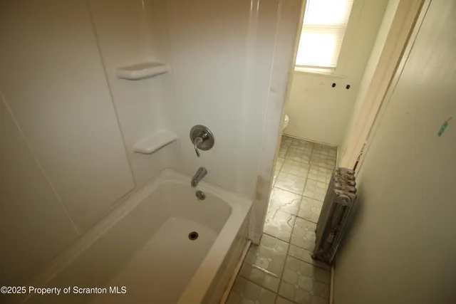 a bathroom with a tub and shower