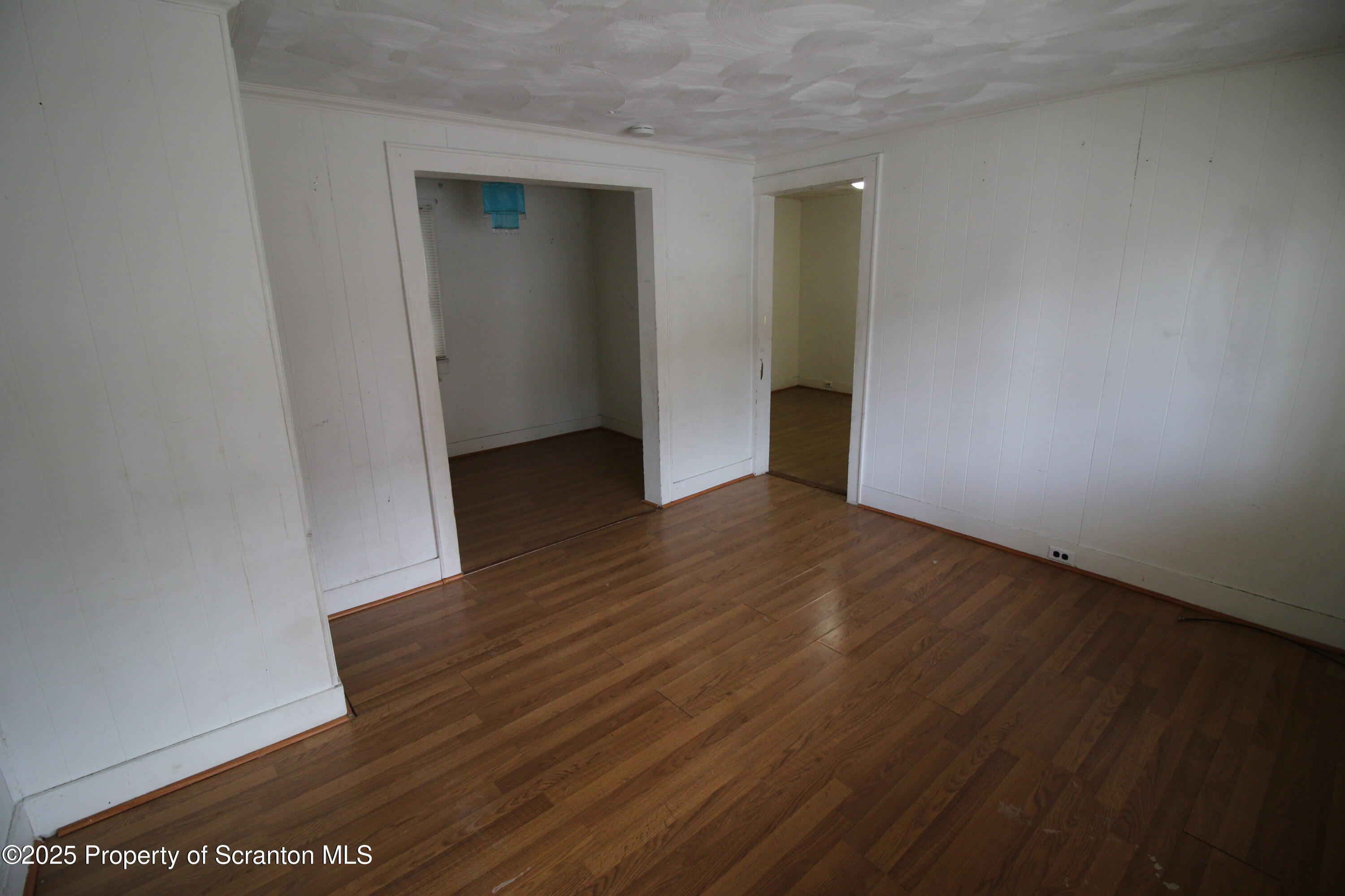 513 Hickory Street Scranton, PA 18505 - Photo 5 of 15 an empty room with wooden floor and closet
