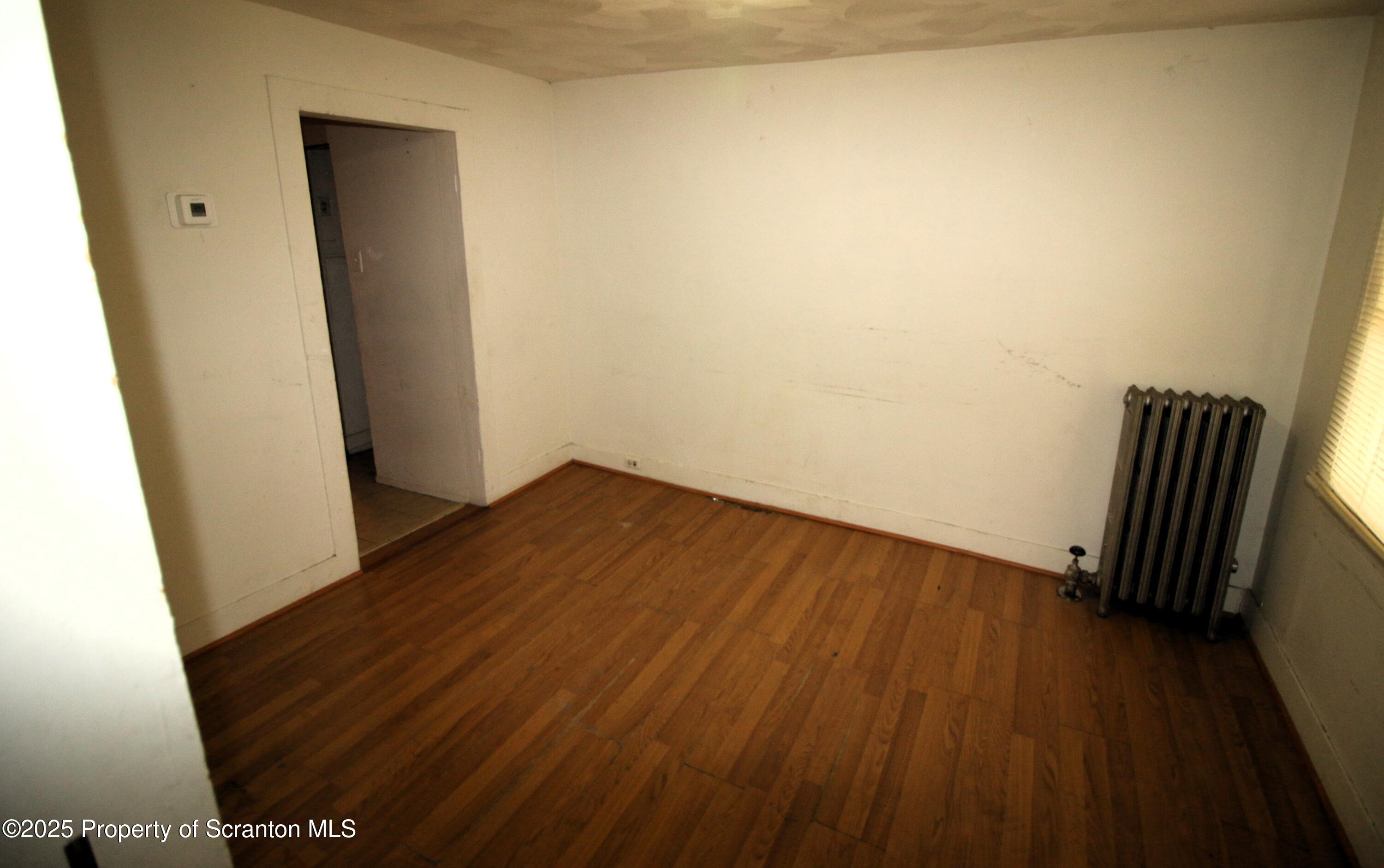 513 Hickory Street Scranton, PA 18505 - Photo 8 of 15 a view of room with wooden floor and chair