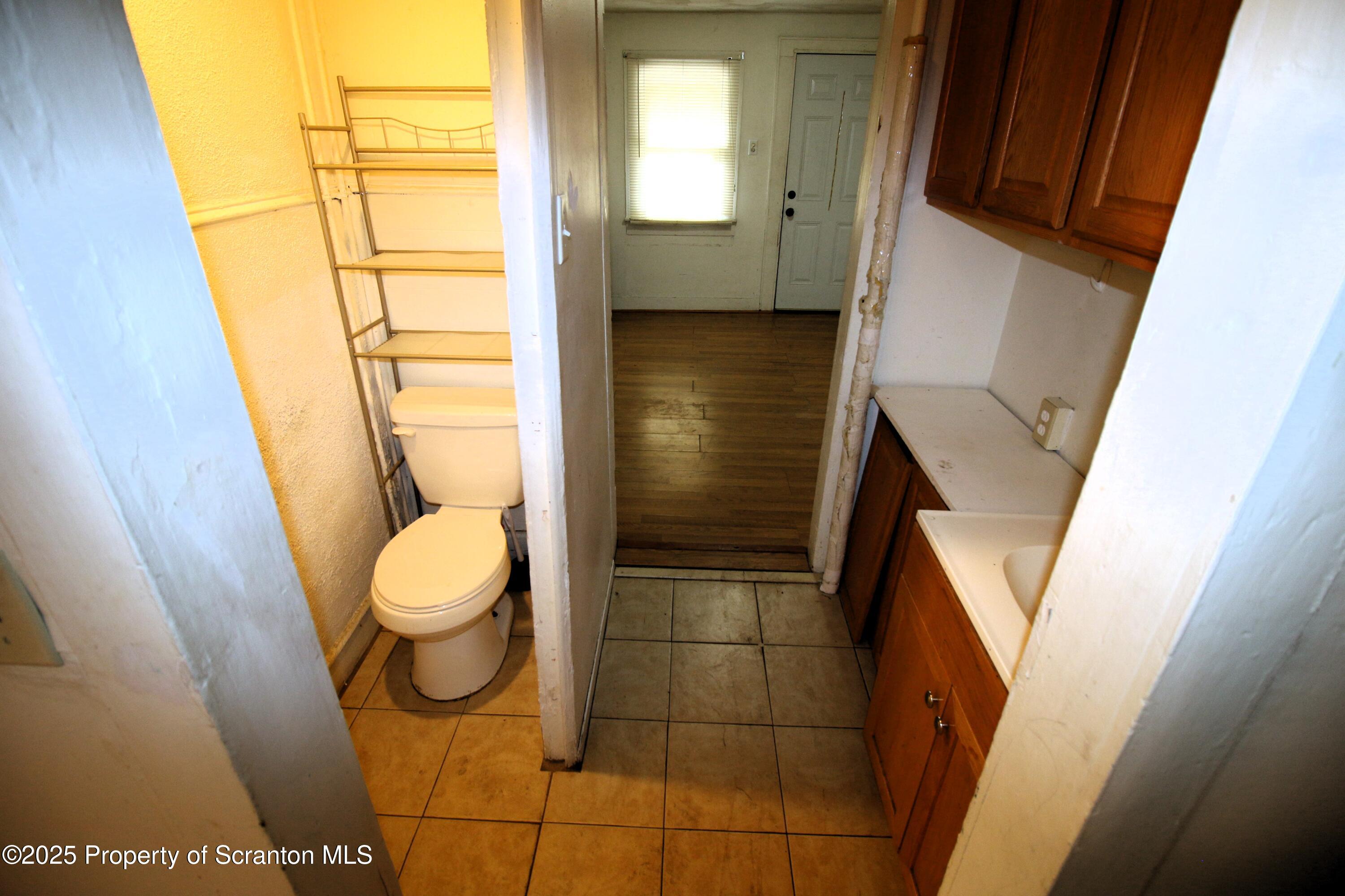 513 Hickory Street Scranton, PA 18505 - Photo 10 of 15 a bathroom with a toilet and a sink