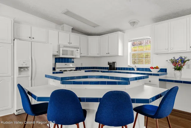 a kitchen with stainless steel appliances a dining table and chair