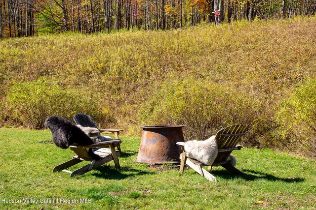 a backyard of a house with table and chairs