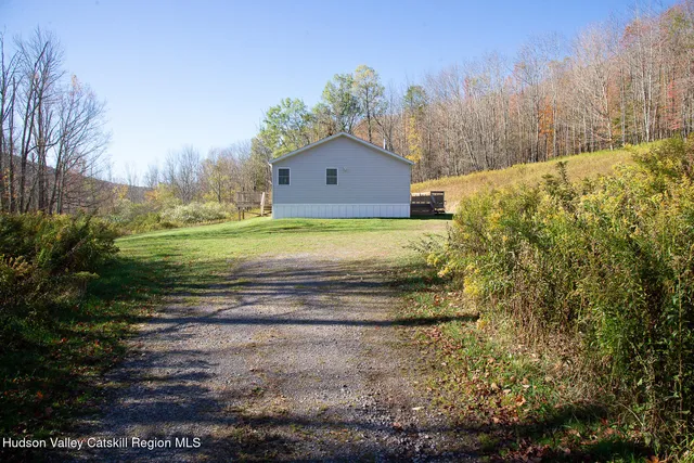 a wooden bench sitting in middle of a field